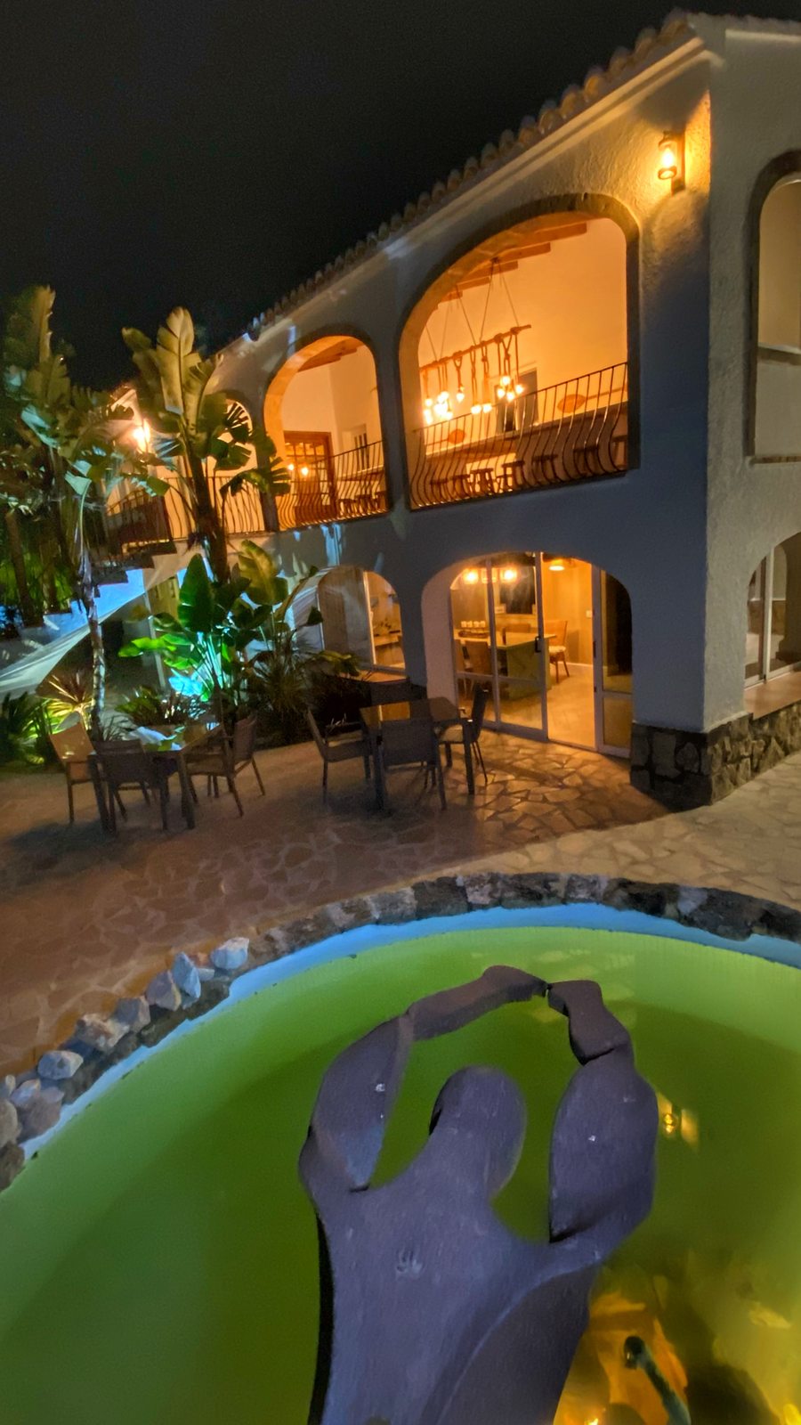 The fountain arching into the rock pool after dark
