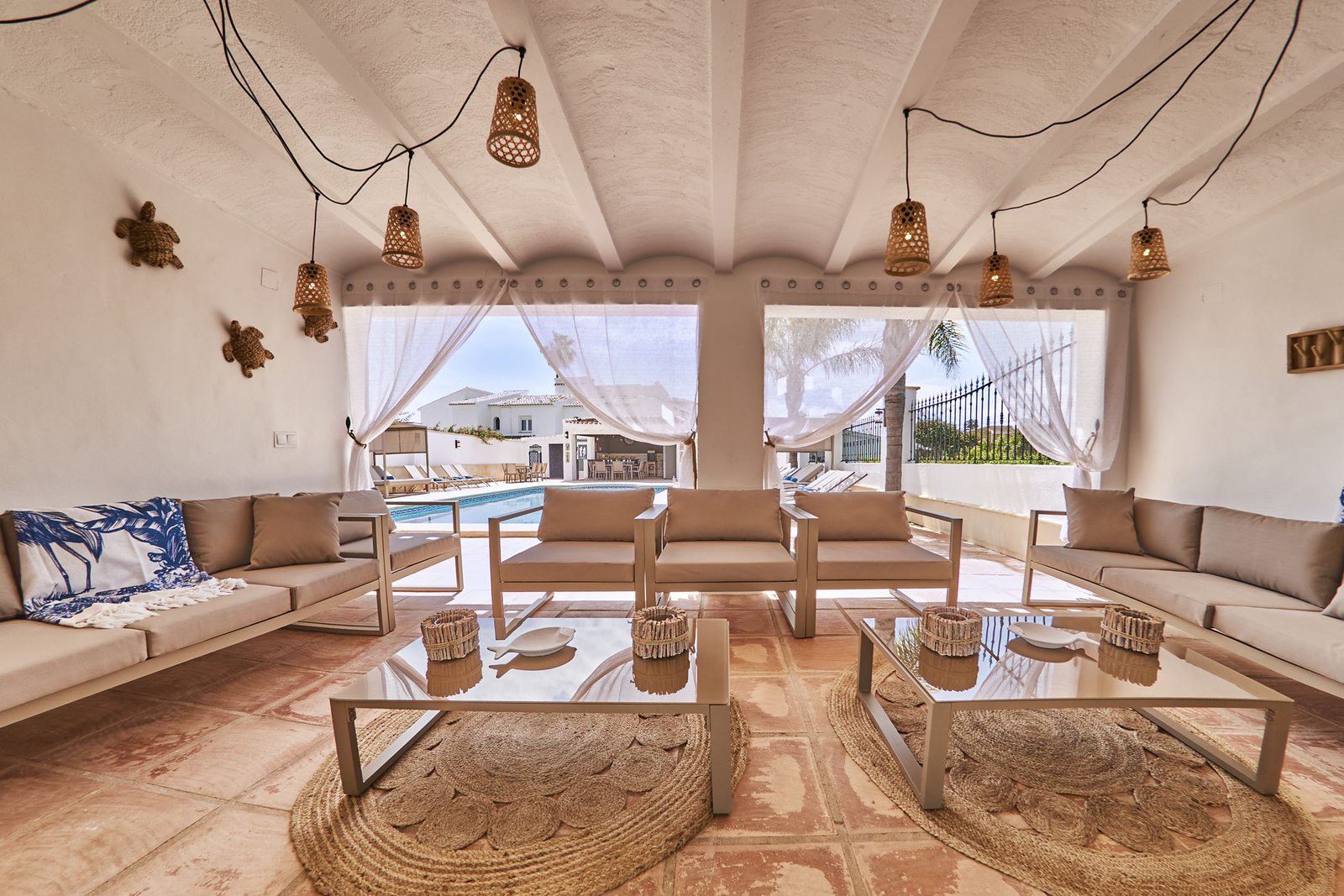 The cabana lounge with its curtains open to the pool