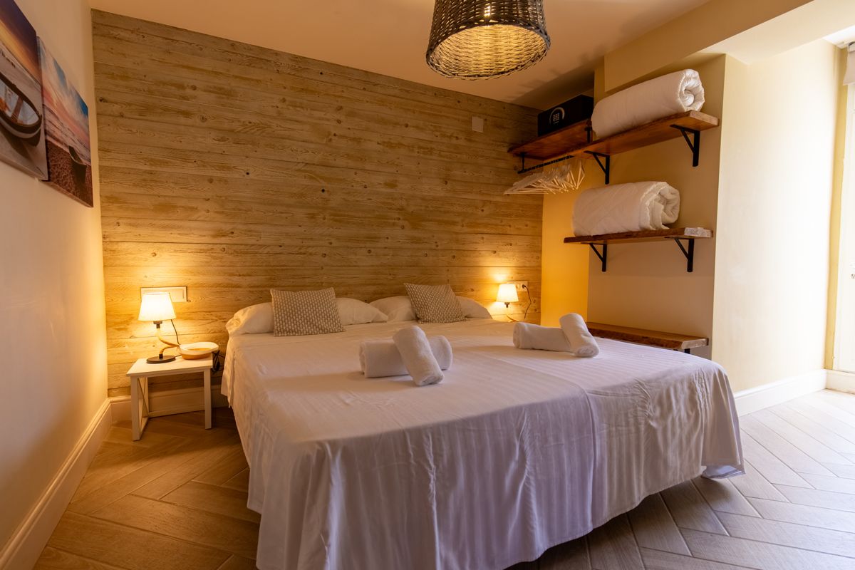 Dormitorio con fotografías del mar sobre la cama — Nauticaa, ala uno de Villa Palmview, Jávea