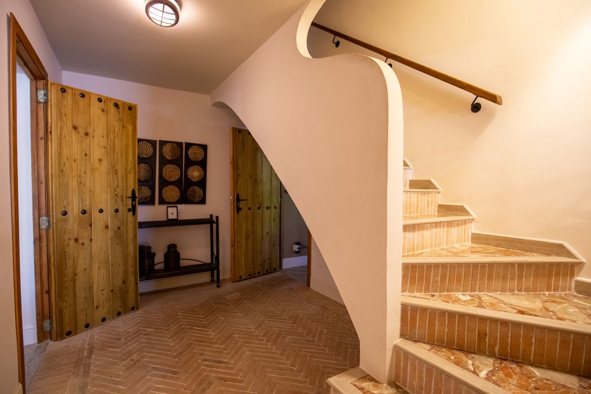 Hallway with wooden doors under the stairs — Nauticaa, wing one of Villa Palmview, Jávea