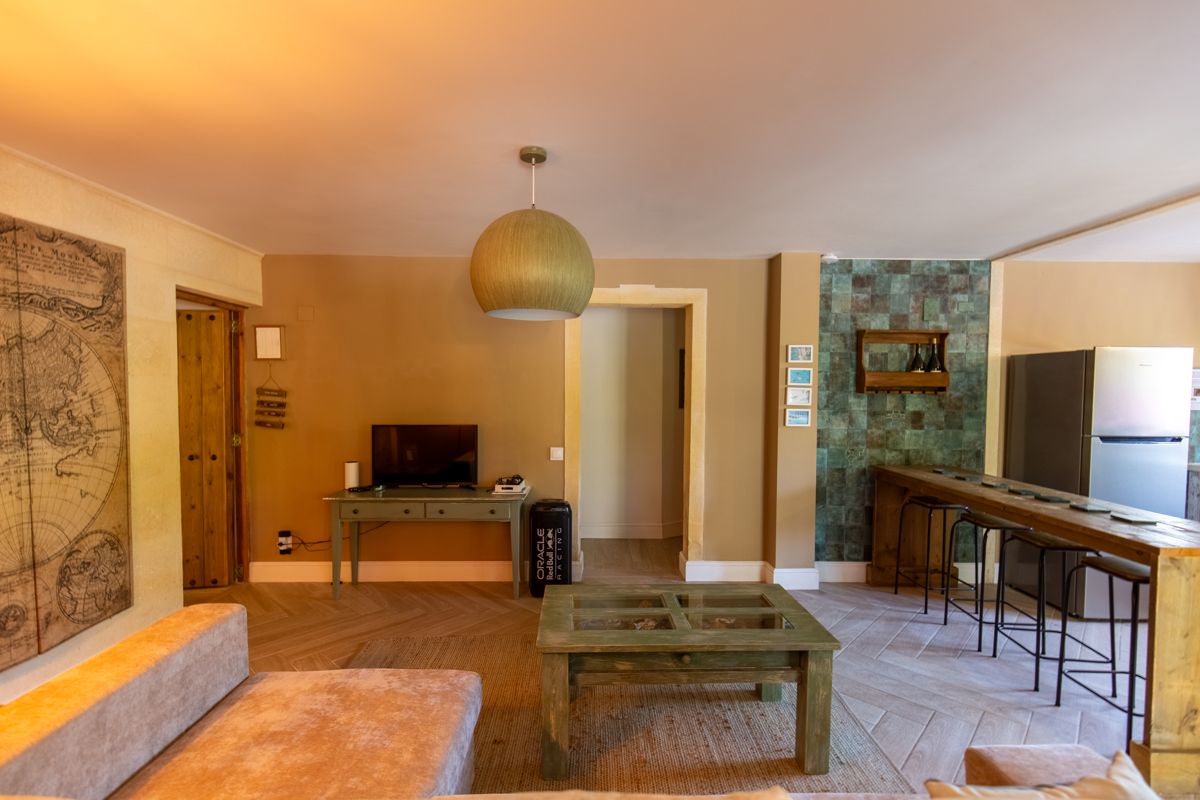Living room with coffee table and wall map — Nauticaa, wing one of Villa Palmview, Jávea