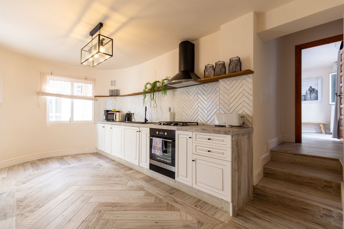 White kitchen with island and extractor — 20,000 Leagues Under the Sea, wing two of Villa Palmview, Jávea