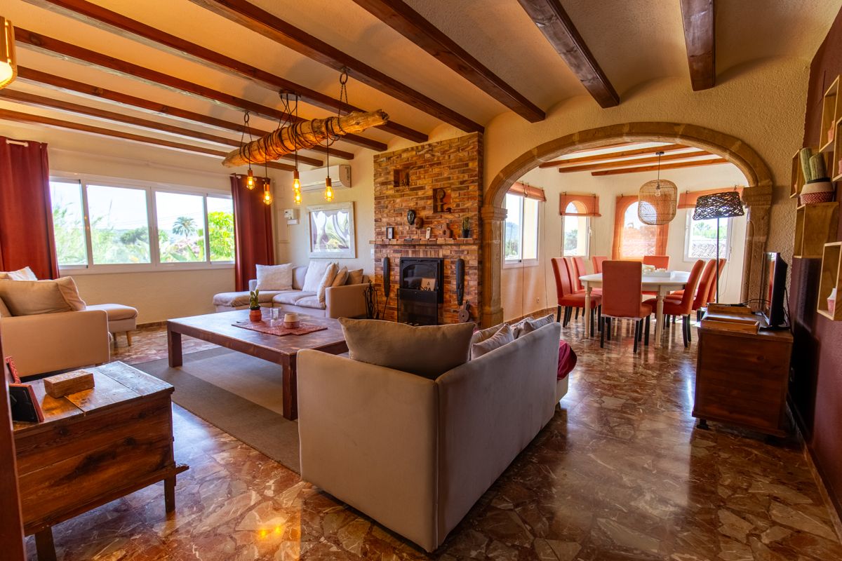 Living room with beamed ceiling and fireplace — Mystique Travels, wing three of Villa Palmview, Jávea