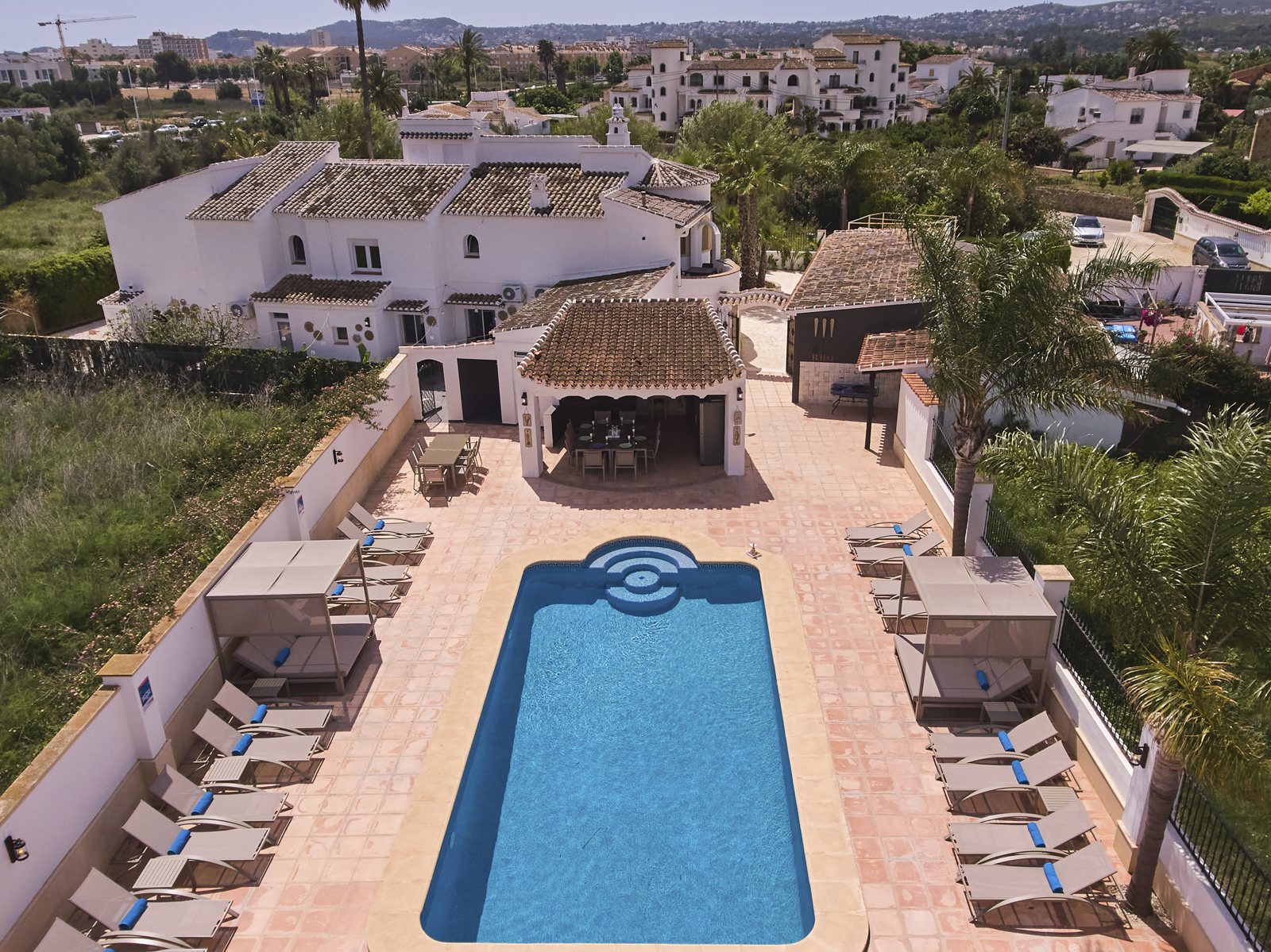 Aerial view straight down over the pool terrace and loungers