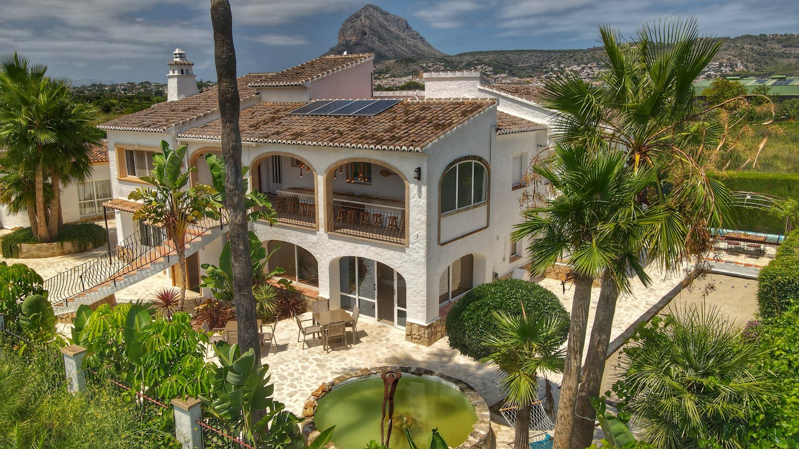 Villa Palmview from the air with palms and the Montgó behind