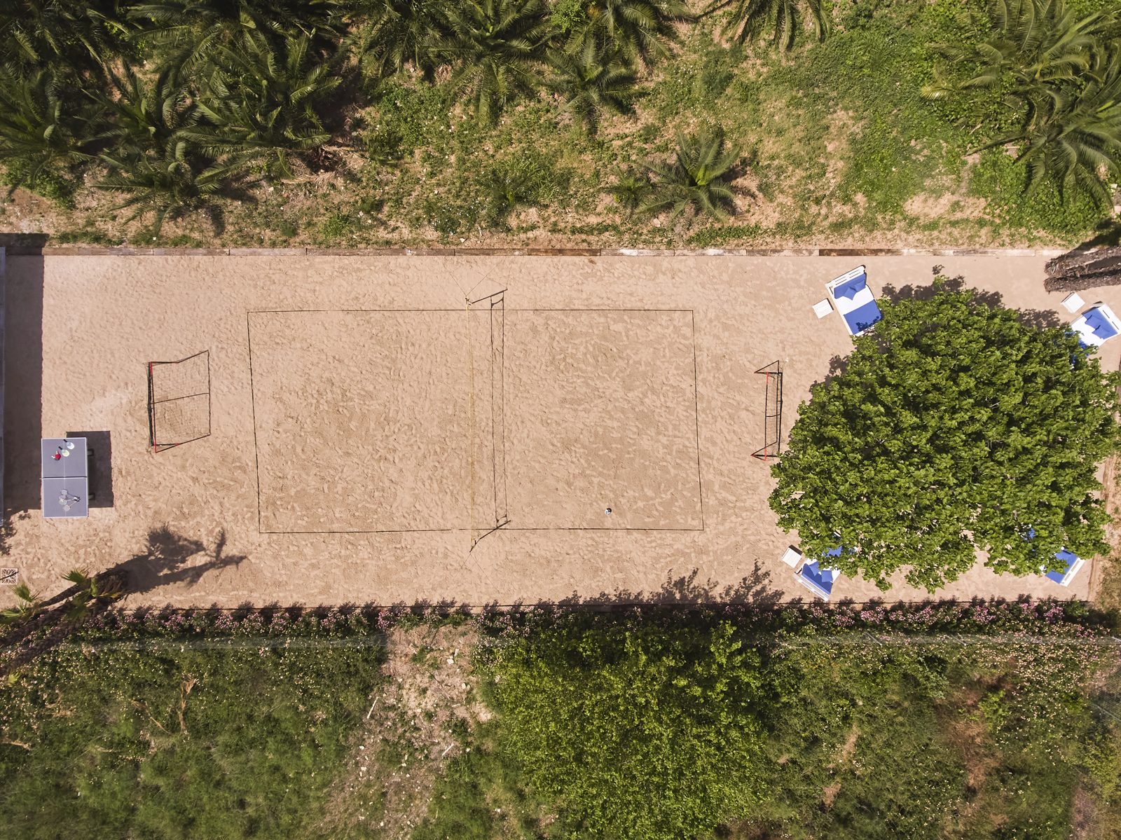 The sandy area on the estate from above, with the volleyball court