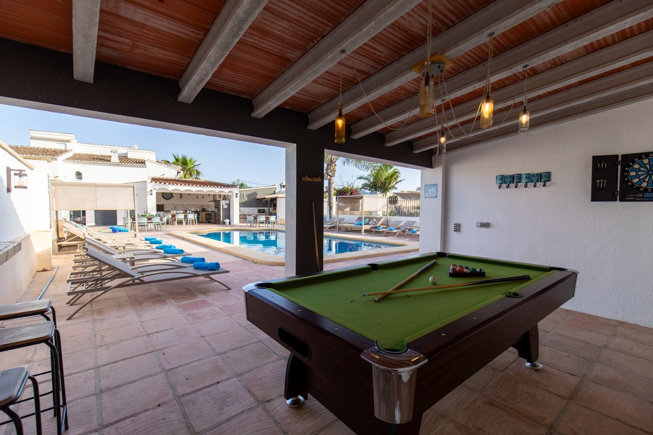 Games room with pool table opening onto the swimming pool