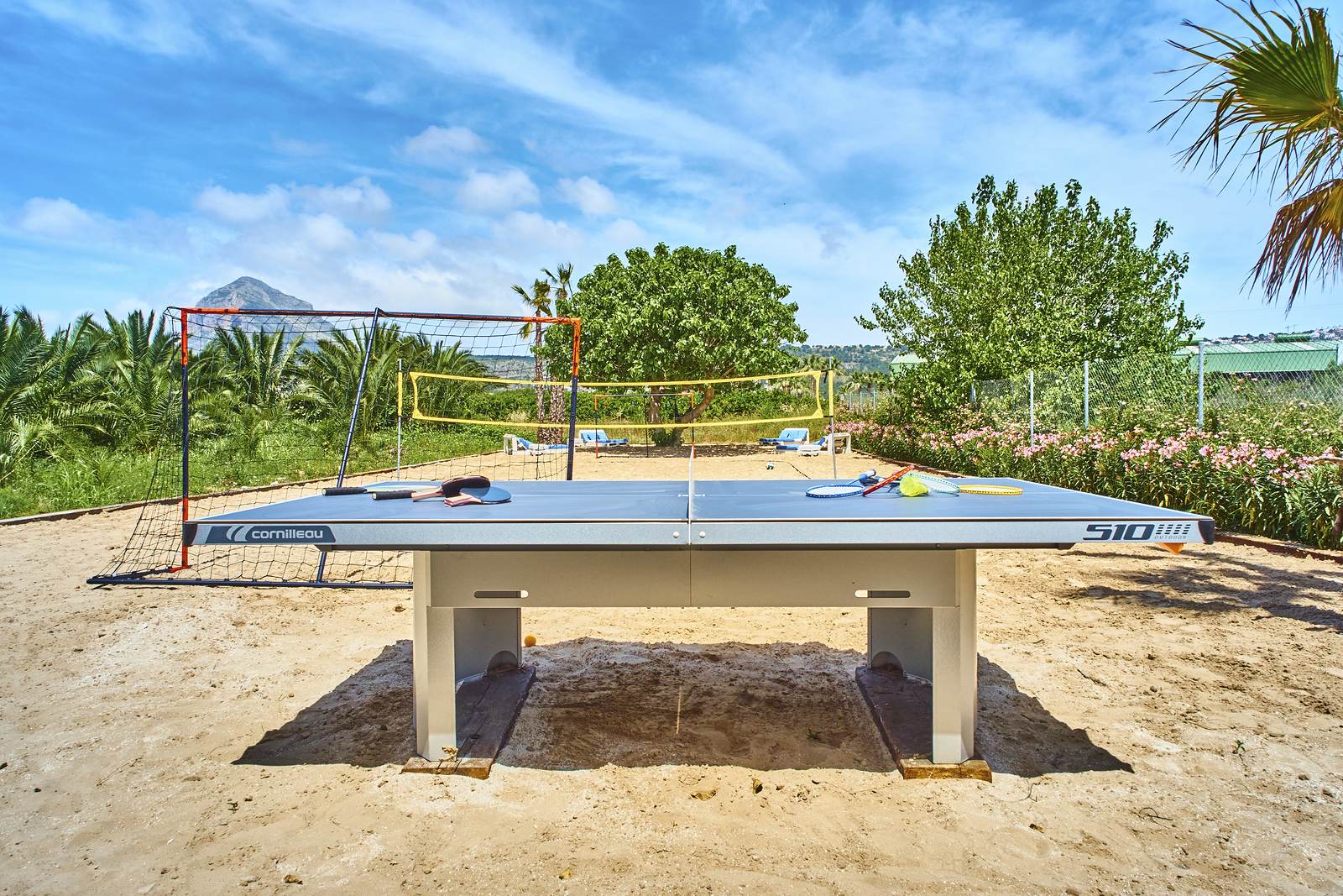 Table tennis and volleyball on the sand, the Montgó behind